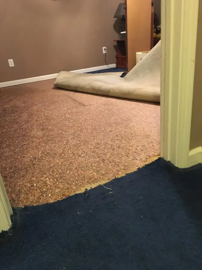 Carpet pad removal revealing water damage during Drying & Dehumidification in New Braunfels